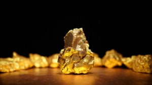 Closeup of a large gold nugget. stocks under $10