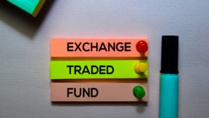 close-up of the phrase "exchange traded fund" on three colorful papers pinned to a wall by colorful pushpins