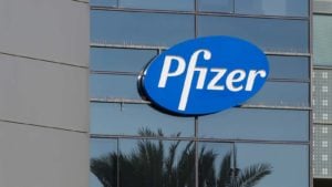 blue Pfizer logo on the windows of a corporate building PFR stock