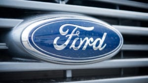 Ford logo badge on grill of car