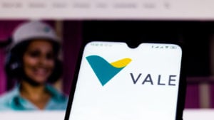 the Vale logo displayed on a mobile phone with the company's webpage in the background