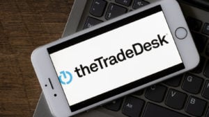 The logo for The Trade Desk is displayed on a smart phone.