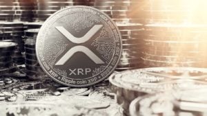 A concept token for XRP with stacks of tokens in the background. XRP price predictions.
