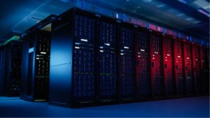 Image of computer servers lined up in a dark room