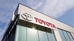 Toyota (TM) logo on the building of a dealership during daylight