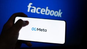 META stock logo is shown on a device screen. Meta is the new corporate name of Facebook.