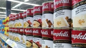 a grocery store aisle stocked with cans and cans of Campbell's Soup