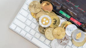 A photo of various crypto coins on a computer keyboard.