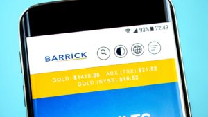 The Barrick Gold (GOLD) logo is displayed on a smartphone screen over a bright blue background.