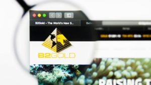 b2gold (BTG) logo on a web browser enlarged by a magnifying glass