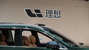 Li Auto (Li Xiang) brand logo and electric car in store. A Chinese EV(electric vehicle) company