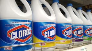 Clorox bleach bottles lined up on a store shelf.