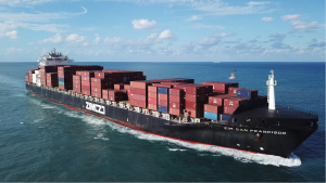 A large ULCV container ship underway, sails on open water fully loaded with containers and cargo - the ZIM San Francisco