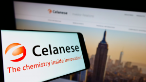 Cellphone with logo of US chemicals company Celanese Corporation (CE) on screen in front of business website Focus on center-left of phone display