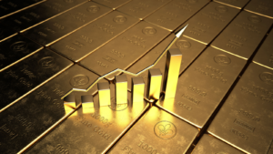 An image of a rising bar graph on top of gold bars, representing gold stocks