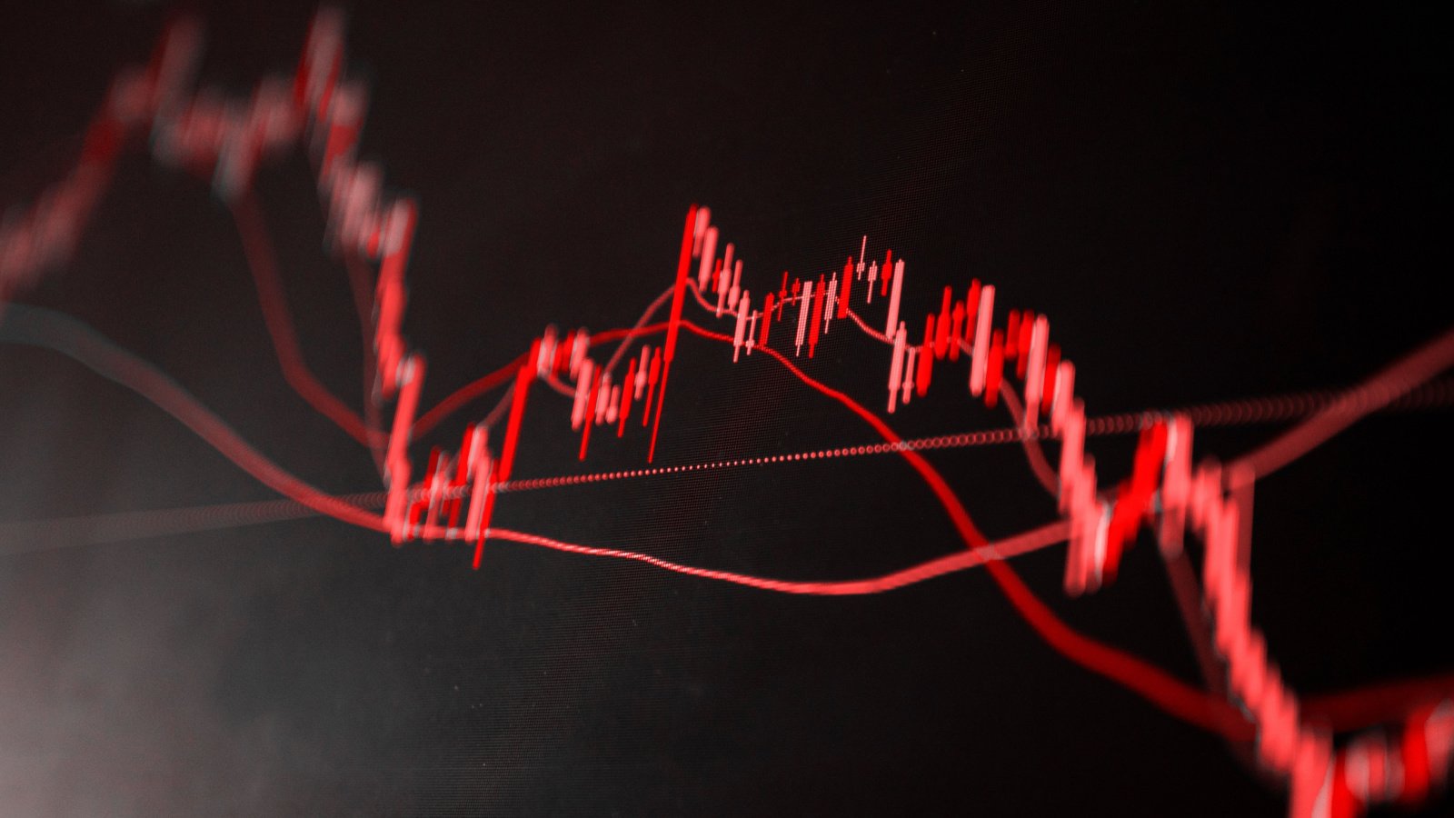 Red stock chart on black screen heading downward, symbolizing a stock market crash